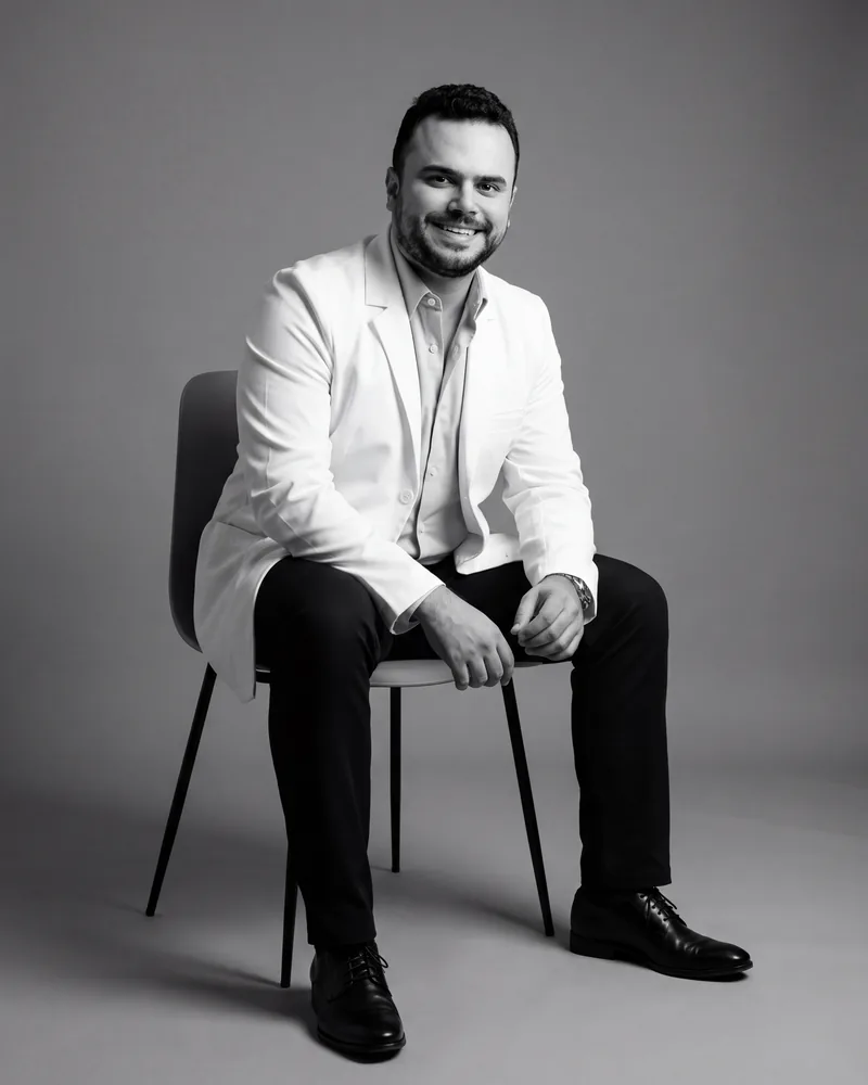 Dr. Daniel Avezoff, dentist, seated in a black-and-white studio portrait