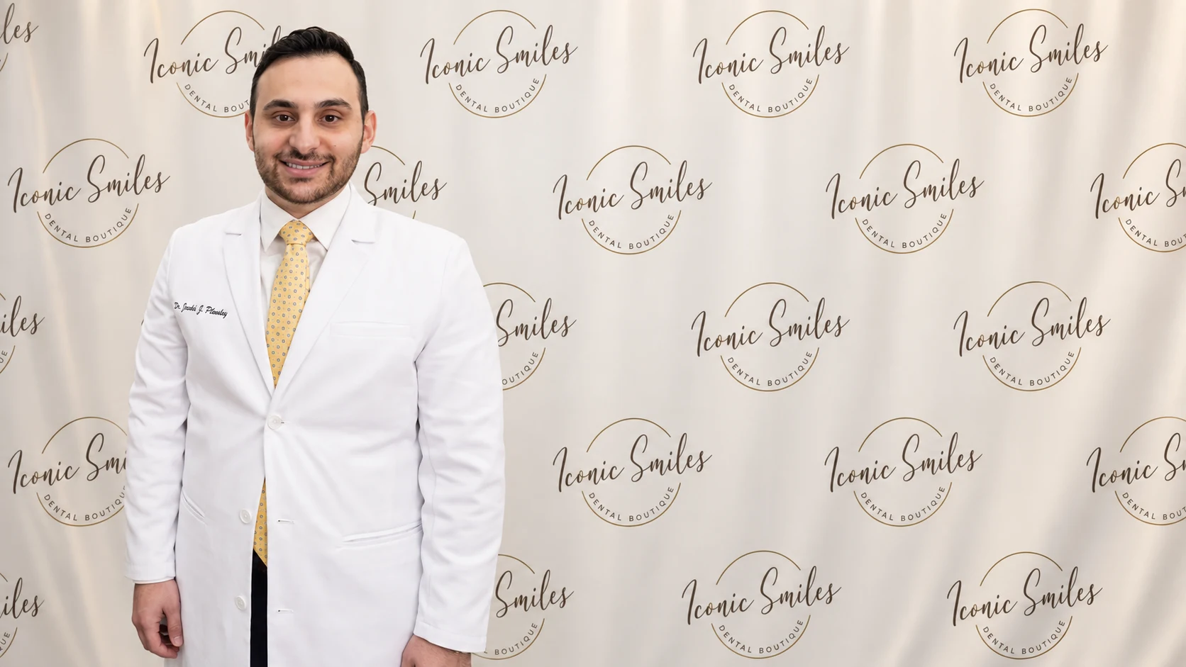 Portrait of Dr. Jacob J. Pleshty with an Iconic Smiles branded backdrop