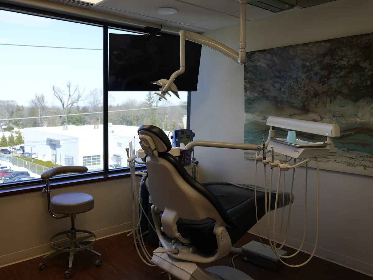 Sunlit treatment room with a window view at the Roslyn office