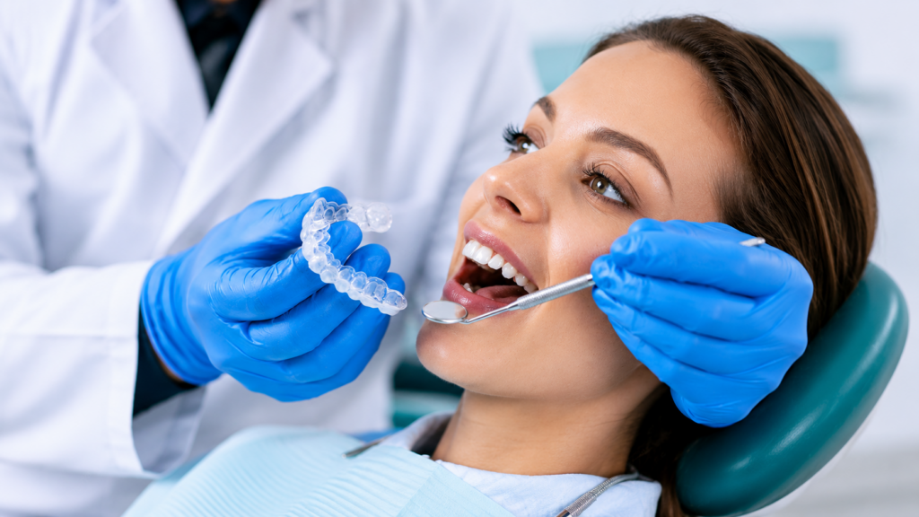 Female patient discussing natural-looking cosmetic dentistry treatment with a dentist in Queens